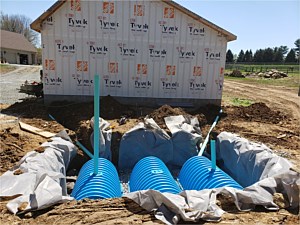 Underground water storage system to catch water from gutters on new garage build