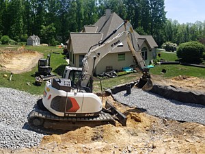 Large underground water storage system to capture water from a new patio and swimming pool