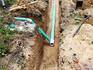 Routing downspouts into underground water storage chamber