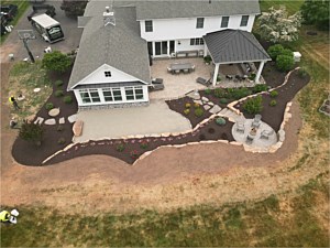 Landscape installation with boulder walls, steps, and stepping stones in Telford