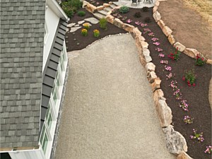 Landscape installation above boulder wall with annual flowers in Telford