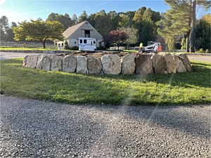 Raised planting bed with boulder wall