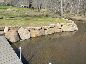 Boulder wall on pond bank